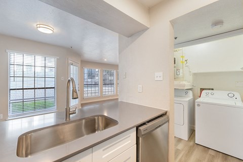 a kitchen with a sink and a washer and dryer